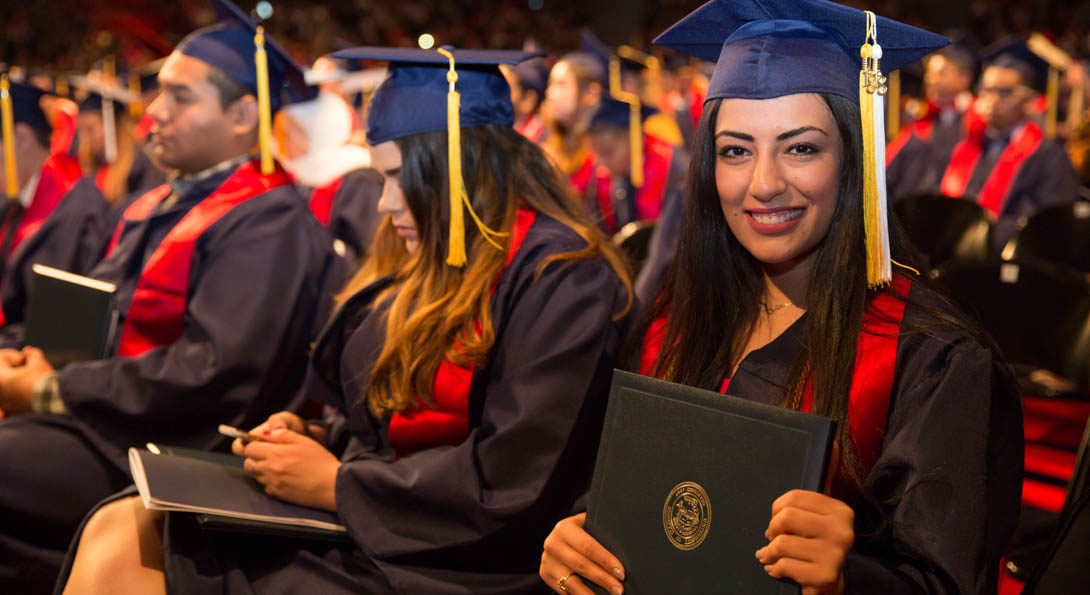 A student holding her diploma