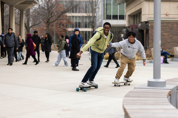 Students skateboarding on the quad