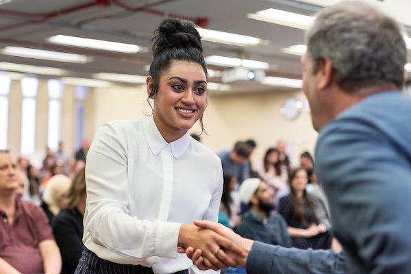 Student shaking hand of professor during award event