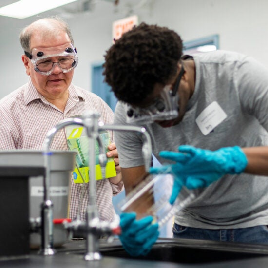 Professor in a lab teaching.