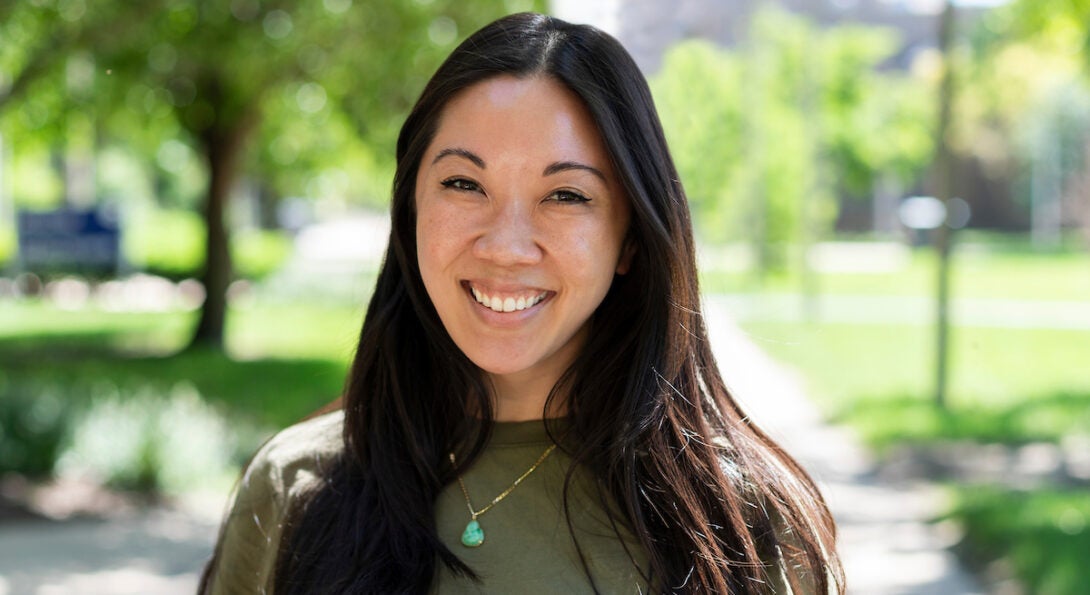 Loretta Hsueh smiling on the campus of the University of Illinois Chicago on a warm summer day in the sun.