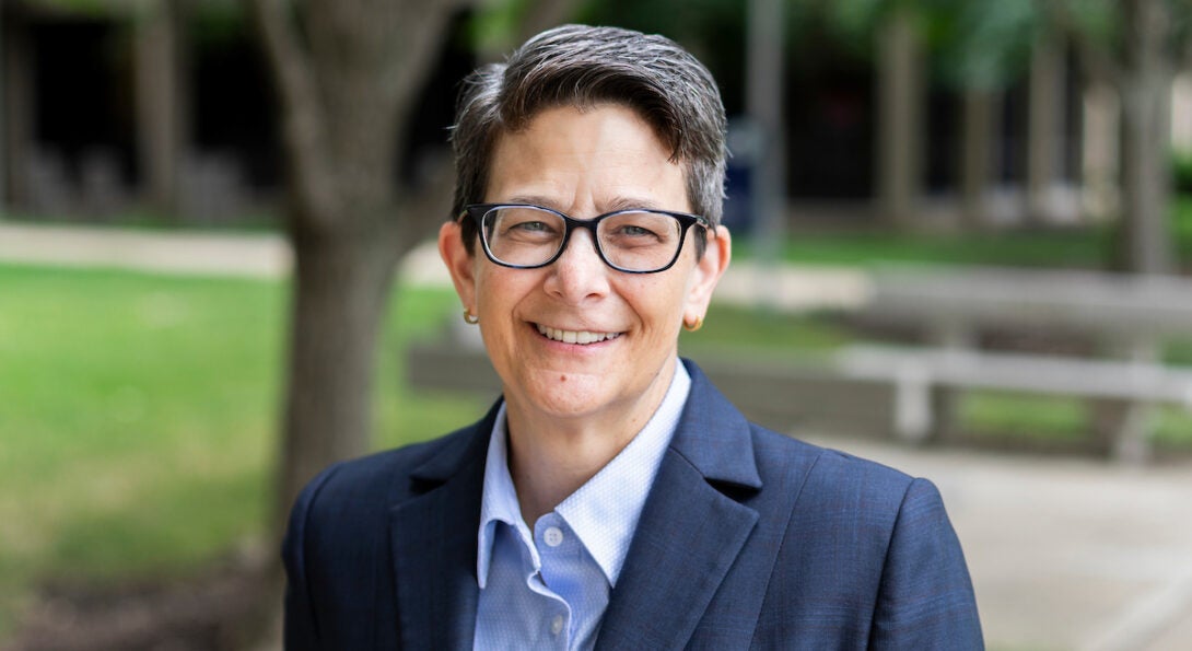 Dean Lisa Freeman smiling in front of University of Illinois Chicago campus