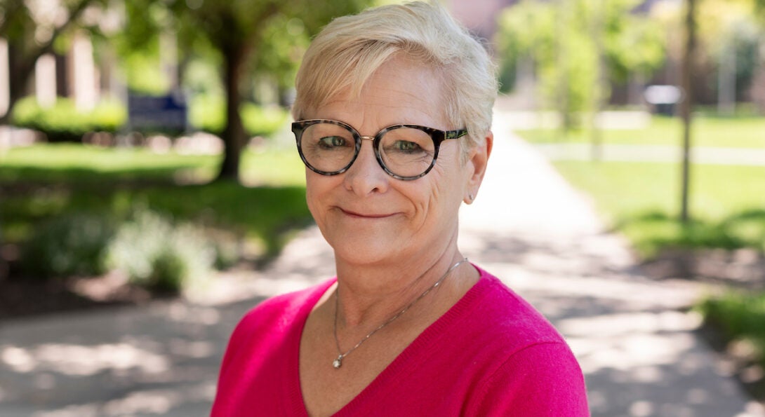 LAS Emerita Professor Linda J. Skitka in bright pink shirt on UIC's campus in the summer.