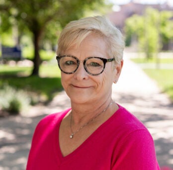 LAS Emerita Professor Linda J. Skitka in bright pink shirt on UIC's campus in the summer.
                  