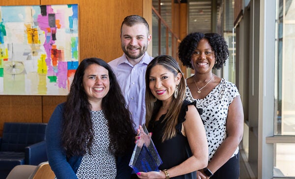 Liz Herrera with NACE award and team