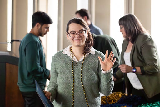 Student waving during award ceremony