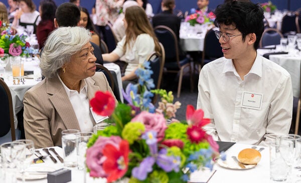 Student and donor sit speaking at Scholarship Luncheon for LAS students