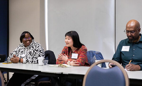 Three speakers sit engaged in discussion at UIC sociology event