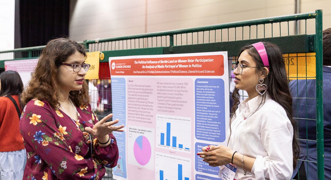 Two students discuss their sciences projects at event at UIC