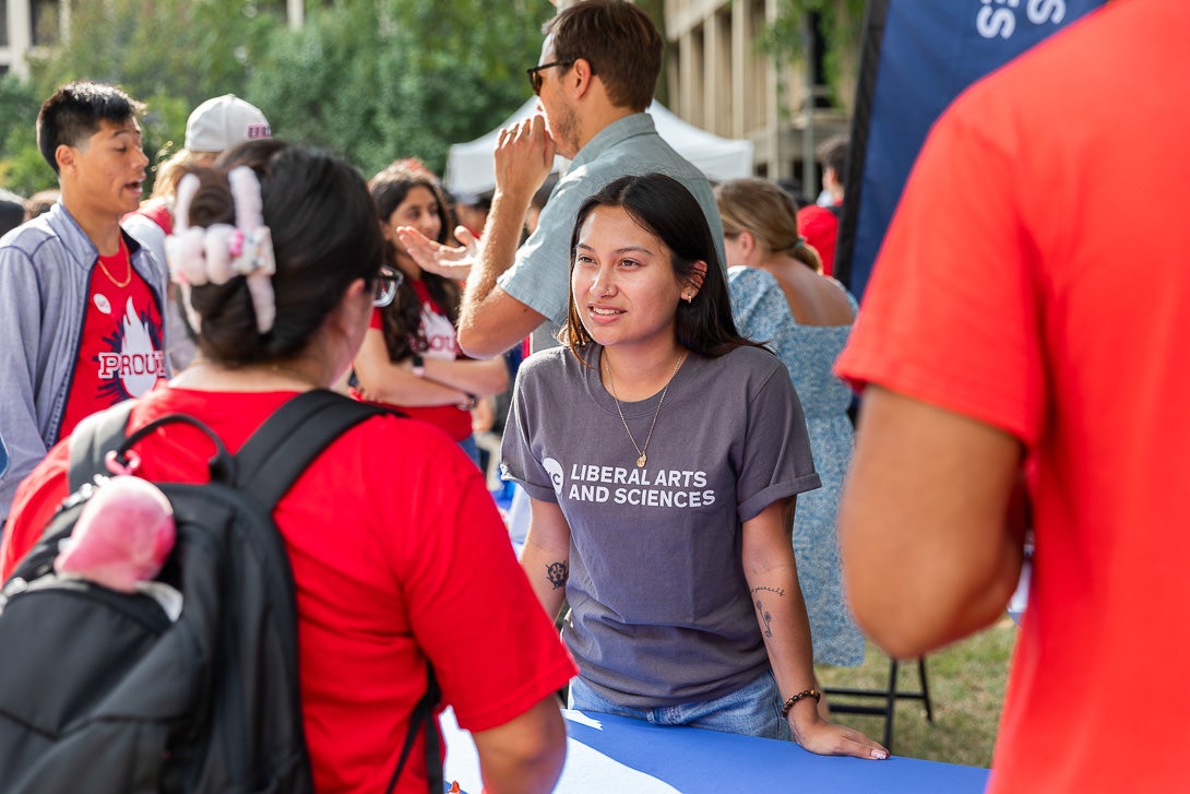 Student Jiselle Plata speaks with another student at Convocation in fall of 2024