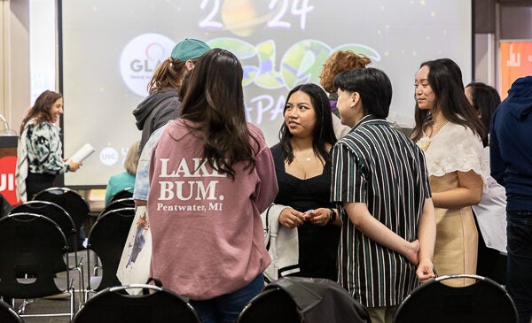 Students standing and talking at GLAS event