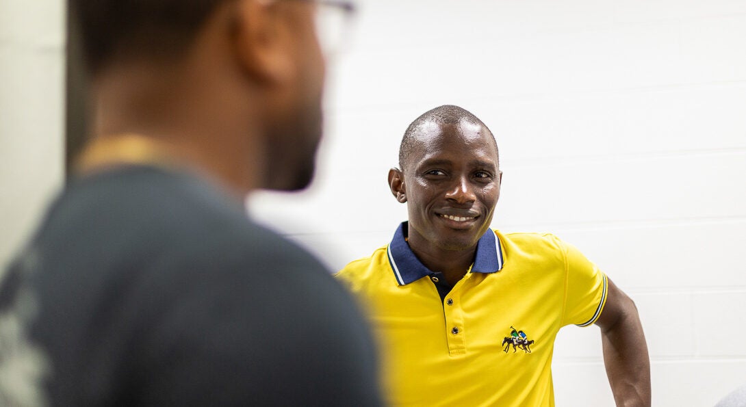 Student smiling at professor as they discuss class problem