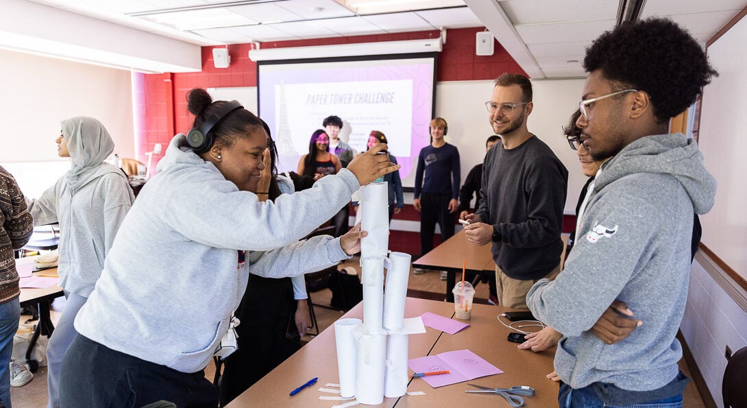 Students making paper tower during team building activity in LAS 110 class