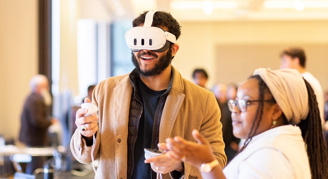 Students at AI Impact event wearing VR goggles and engaging with digital interface