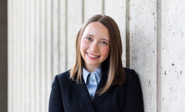 LASURI Student Isabel Kapustka wearing a blue button up shirt and navy blazer