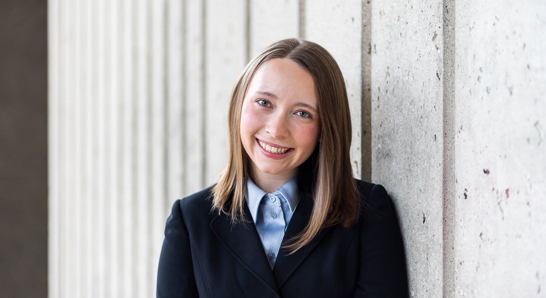 LASURI Student Isabel Kapustka wearing a blue button up shirt and navy blazer