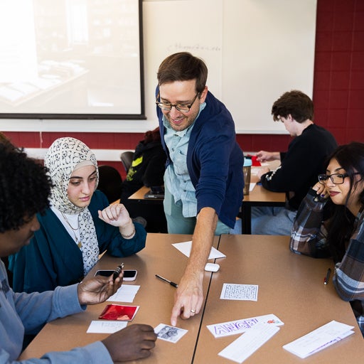 LAS 110 teacher Casey Thayer advises students on career game during class