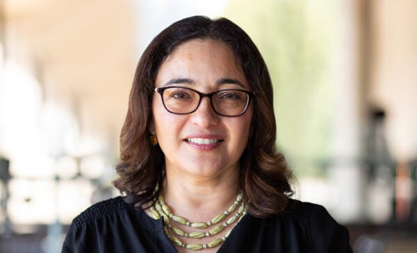 Lilia Fernandez has short brown hair, brown glasses and wears a black blouse