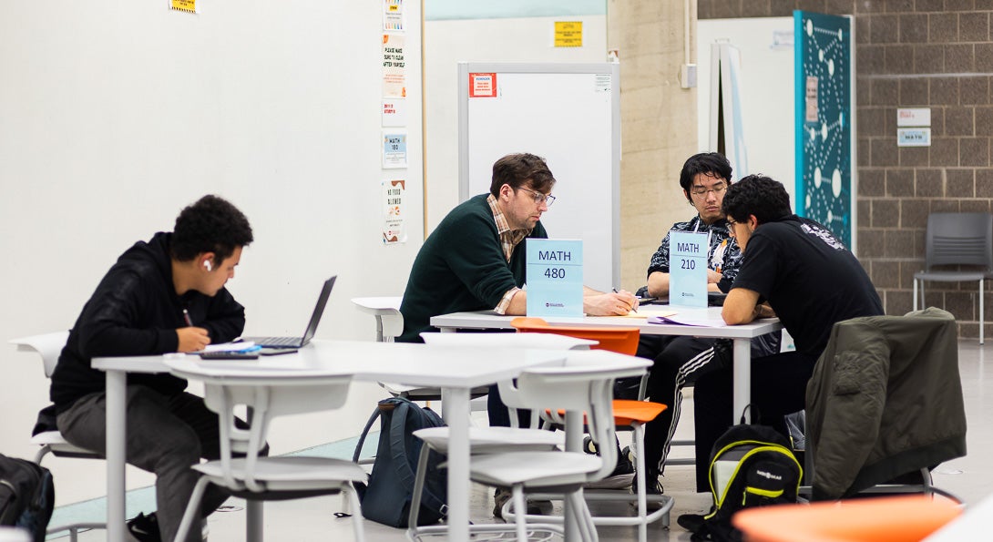 Students working with teaching assistant at the Math and Science Learning Center