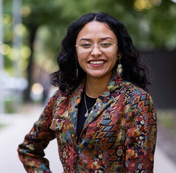 English student Dazalyn Moreno wears wire rimmed glasses and colorful blazer
                  