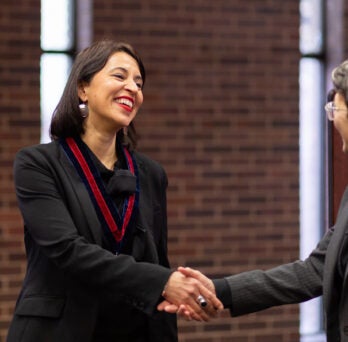 Tarini Bedi shakes the hand of LAS Dean Lisa A. Freeman at event
                  