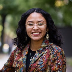 English student Dazalyn Moreno wears wire rimmed glasses and colorful blazer