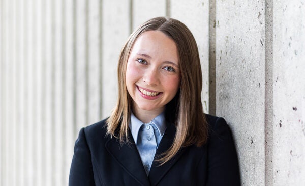 LASURI Student Isabel Kapustka wearing a blue button up shirt and navy blazer